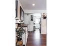 Bright entryway with dark hardwood floors, view into kitchen at 360 S 30Th Ave, Brighton, CO 80601