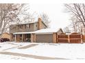 Two-story house with brick and siding exterior, attached garage, and wooden fence at 360 S 30Th Ave, Brighton, CO 80601