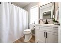 Bright bathroom featuring a white vanity, black fixtures, and modern shower curtain at 1786 Quartz St, Castle Rock, CO 80109