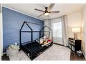 Cozy bedroom with a built-in bed and charming blue accent wall at 1786 Quartz St, Castle Rock, CO 80109