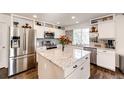 Modern kitchen with granite counters, stainless steel appliances and center island at 1786 Quartz St, Castle Rock, CO 80109