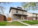 Charming two-story home with covered porch and well-manicured lawn at 3028 N Gilpin St, Denver, CO 80205