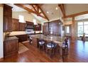 Gourmet kitchen with a marble island, chef's appliances, and wooden cabinets at 5195 Raintree Cir, Parker, CO 80134
