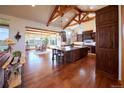 Spacious kitchen with wood island, beams, cabinets and views to the large dining space at 5195 Raintree Cir, Parker, CO 80134