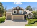 Charming two-story home featuring a brick and siding facade, a three-car garage, and manicured landscaping at 8833 Maplewood Dr, Highlands Ranch, CO 80126
