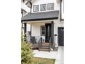 Cozy front porch with black railing offers seating and a welcoming entrance at 2020 Teller St, Lakewood, CO 80214