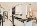 Modern kitchen boasts sleek white cabinets, black granite countertops, and updated appliances at 7865 E Mississippi Ave # 1501, Denver, CO 80247
