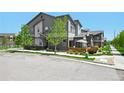Lovely townhome features a well-maintained lawn, a charming patio, and modern architectural design at 12497 W Virginia Ave, Lakewood, CO 80228