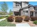 Enjoy outdoor living on the townhome patio, featuring a charming wood fence and comfortable seating at 12497 W Virginia Ave, Lakewood, CO 80228