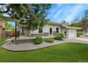 Charming single story home with manicured lawn, rock landscaping, and covered front porch at 1202 9Th Ave, Longmont, CO 80501