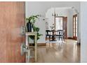 Inviting foyer featuring hardwood floors, arched doorways, and a glimpse into the dining area at 2654 Forest St, Denver, CO 80207