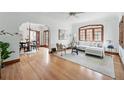 Bright living room with hardwood floors, large windows, and a comfortable seating area at 2654 Forest St, Denver, CO 80207