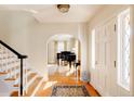 Bright entryway features hardwood floors, staircase and arched doorway leading to the living spaces at 5555 E 17Th Avenue Pkwy, Denver, CO 80220