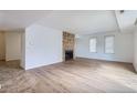 Inviting living room featuring modern floors, a cozy fireplace, and plenty of natural light at 6475 S Dayton St # 102, Englewood, CO 80111