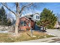 Two-story brick home with attached garage and mature trees at 458 Whitetail Cir, Lafayette, CO 80026