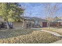 A charming brick house with a well-kept front yard and walkway leading to the front door at 110 E 104Th Pl, Northglenn, CO 80233