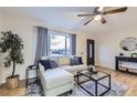 Bright living room showcasing a comfortable couch, hardwood flooring, and a large window at 110 E 104Th Pl, Northglenn, CO 80233