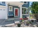 Inviting front porch with a red door, bench seating, potted plants, and white trim that adds curb appeal at 12491 E 106Th Pl, Commerce City, CO 80022