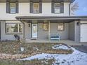 Inviting front porch with a light blue bench and landscaping at 5285 Gladiola St, Arvada, CO 80002