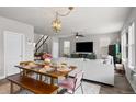 Bright living room with an open floor plan, modern decor, and a view of the staircase at 199 Simmental Loop, Castle Rock, CO 80104