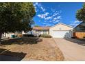 Charming single-story home with manicured lawn and attached two-car garage at 1167 S Ceylon St, Aurora, CO 80017