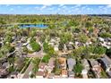 Stunning aerial view of a neighborhood surrounded by lush greenery and a serene lake at 1215 S Ogden St, Denver, CO 80210