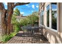 Enjoy outdoor dining on this wooden patio with a table and chair set at 1215 S Ogden St, Denver, CO 80210
