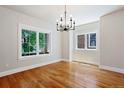 Bright dining room with hardwood floors, modern chandelier, and large windows at 1215 S Ogden St, Denver, CO 80210
