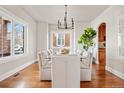 Bright dining room with hardwood floors, modern chandelier, and direct access to the wine cellar at 1215 S Ogden St, Denver, CO 80210