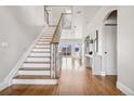 Bright and airy foyer with hardwood floors, staircase, and modern console table at 1215 S Ogden St, Denver, CO 80210