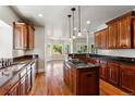 Gourmet kitchen features custom wood cabinets, granite countertops, and a center island with a gas cooktop at 1215 S Ogden St, Denver, CO 80210