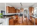 Beautiful kitchen featuring custom cabinets, granite countertops, and a central island with cooktop at 1215 S Ogden St, Denver, CO 80210
