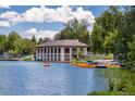 Scenic view of a lakeside boathouse with paddle boats and clear blue water at 1215 S Ogden St, Denver, CO 80210