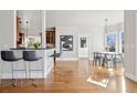 Open concept living area showing bar seating with a dining nook and view of hardwood floors at 1215 S Ogden St, Denver, CO 80210