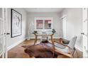 Bright home office featuring hardwood floors, a modern desk, and a comfortable chair at 1215 S Ogden St, Denver, CO 80210