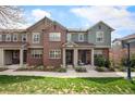 Inviting townhome exterior boasts brick and siding, a charming entryway, and well-maintained landscaping at 767 Roslyn St # 20, Denver, CO 80230