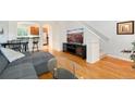 Sunlit living room with hardwood floors, comfy seating, and easy access to kitchen at 767 Roslyn St # 20, Denver, CO 80230