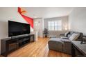 Contemporary living room with hardwood floors, modern decor, and large windows for natural light at 767 Roslyn St # 20, Denver, CO 80230
