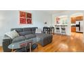 Open-concept living room boasts hardwood floors and a comfortable gray sofa at 767 Roslyn St # 20, Denver, CO 80230