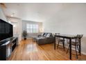 Cozy living room with hardwood floors, ample natural light, and a comfortable gray sectional sofa at 767 Roslyn St # 20, Denver, CO 80230