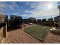 Large, flat backyard featuring a trampoline, swing set, and a designated play area with new turf at 47314 Iris Ave, Bennett, CO 80102