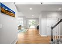 Bright foyer featuring wood floors, a staircase, and access to the living areas at 5951 E Irish Pl, Centennial, CO 80112
