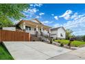 Wide concrete driveway leading up to a charming home with a welcoming front porch at 5372 W 68Th Ave, Arvada, CO 80003