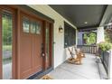 Welcoming front door view to a charming covered porch with rocking chairs and stylish details at 3858 W 117Th Ct, Westminster, CO 80031
