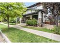 Inviting home showcasing a covered porch, stone pillars, and lush green lawn and landscaping at 3858 W 117Th Ct, Westminster, CO 80031