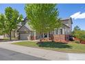 Two-story home with beautiful landscaping, brick accents, and a two-car garage, providing an inviting curb appeal at 4467 Trailside Ln, Castle Rock, CO 80109