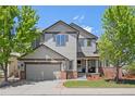 Charming two-story home with a well-manicured lawn, brick accents, and a two-car garage, perfect for suburban living at 4467 Trailside Ln, Castle Rock, CO 80109