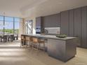 Modern kitchen featuring a large island with seating, stainless steel appliances, and beautiful countertops at 185 Steele St # 211, Denver, CO 80206