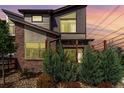 Striking architectural design showcasing modern brick and siding exterior with decorative plantings at 6396 Nelson Ct, Arvada, CO 80004
