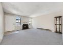 Bright living room with fireplace and carpet at 11860 Harrison St, Thornton, CO 80233